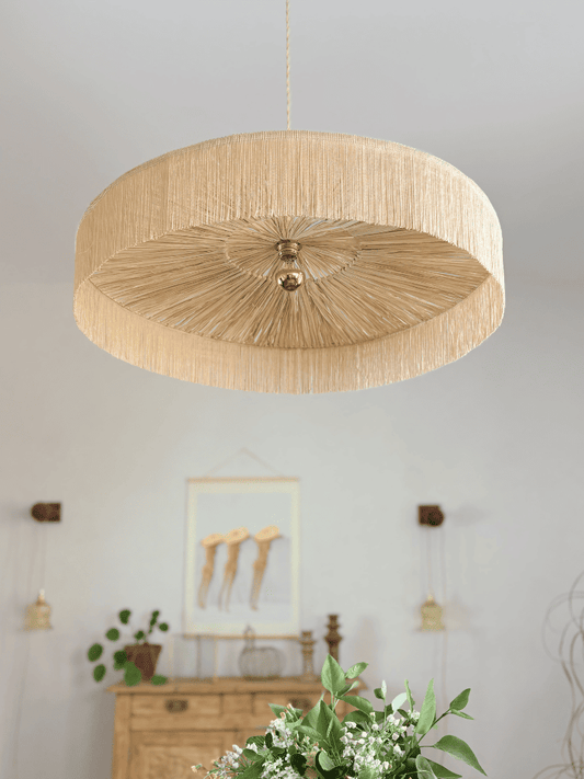 Vue du dessous de la grande suspension Parasol en raphia et franges made in France, mise en situation dans un décoration méditerranéenne.