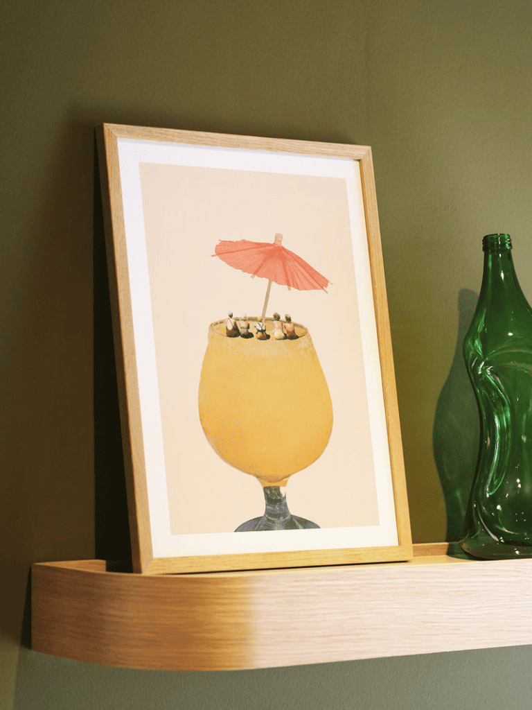 Affiche Vacances dans un verre II encadrée dans un salon lumineux et coloré, ambiance estivale et méditerranéenne